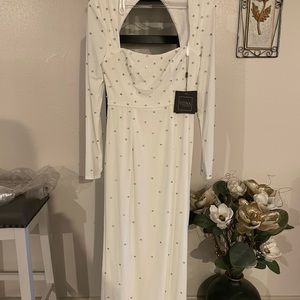 This tags on white gown is studded with crystals and shows off a sexy back!.